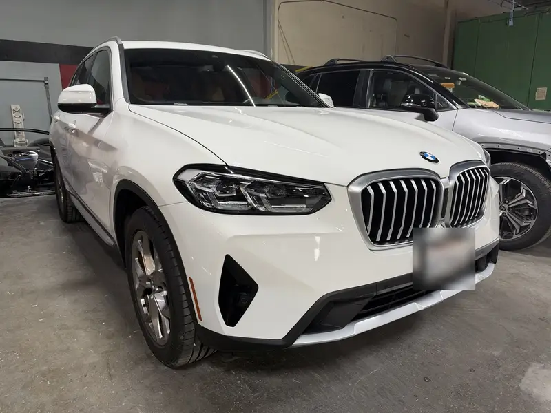 The same 2022 BMW X3 front end after repair, photographed in the Eurocraft shop