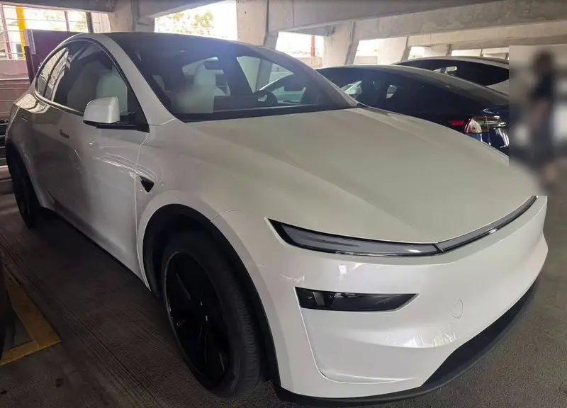 The same 2026 Tesla Model Y after repair, with a new right fender, headlamp and front bumper